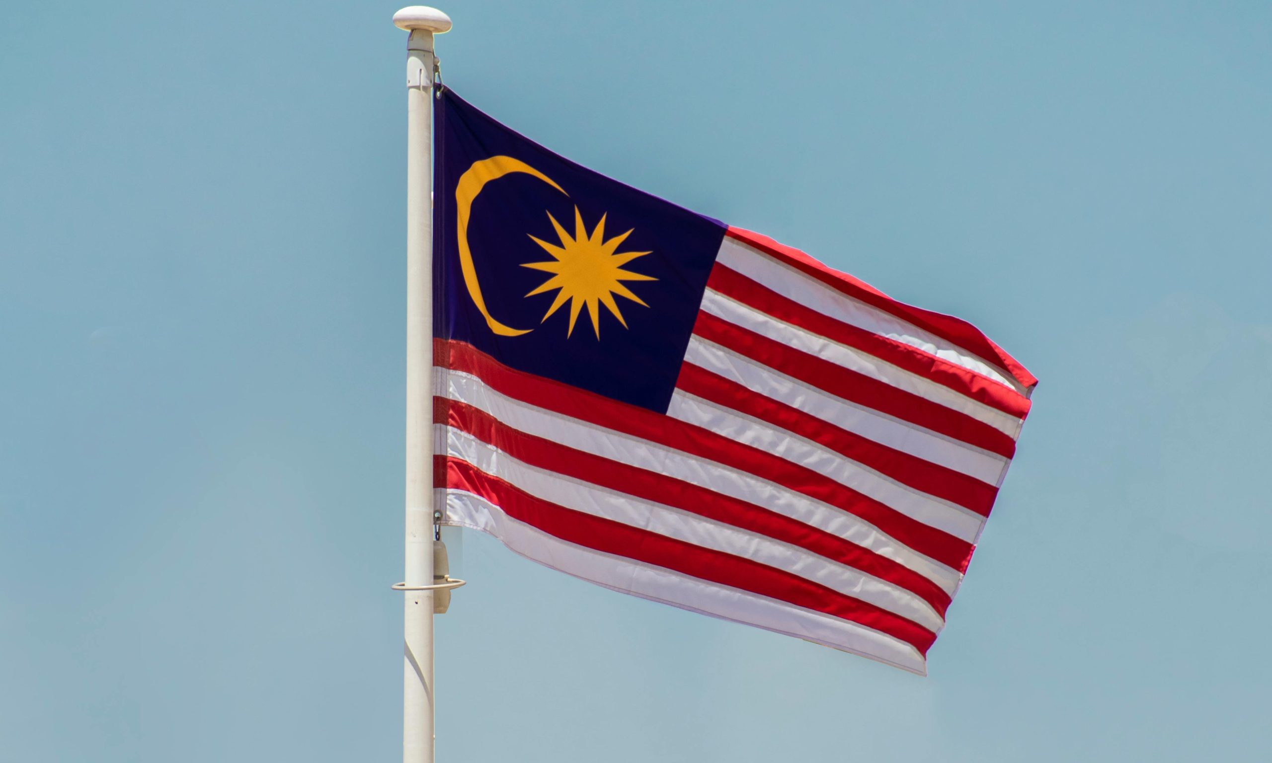 Malaysia' flag waving under the blue sky