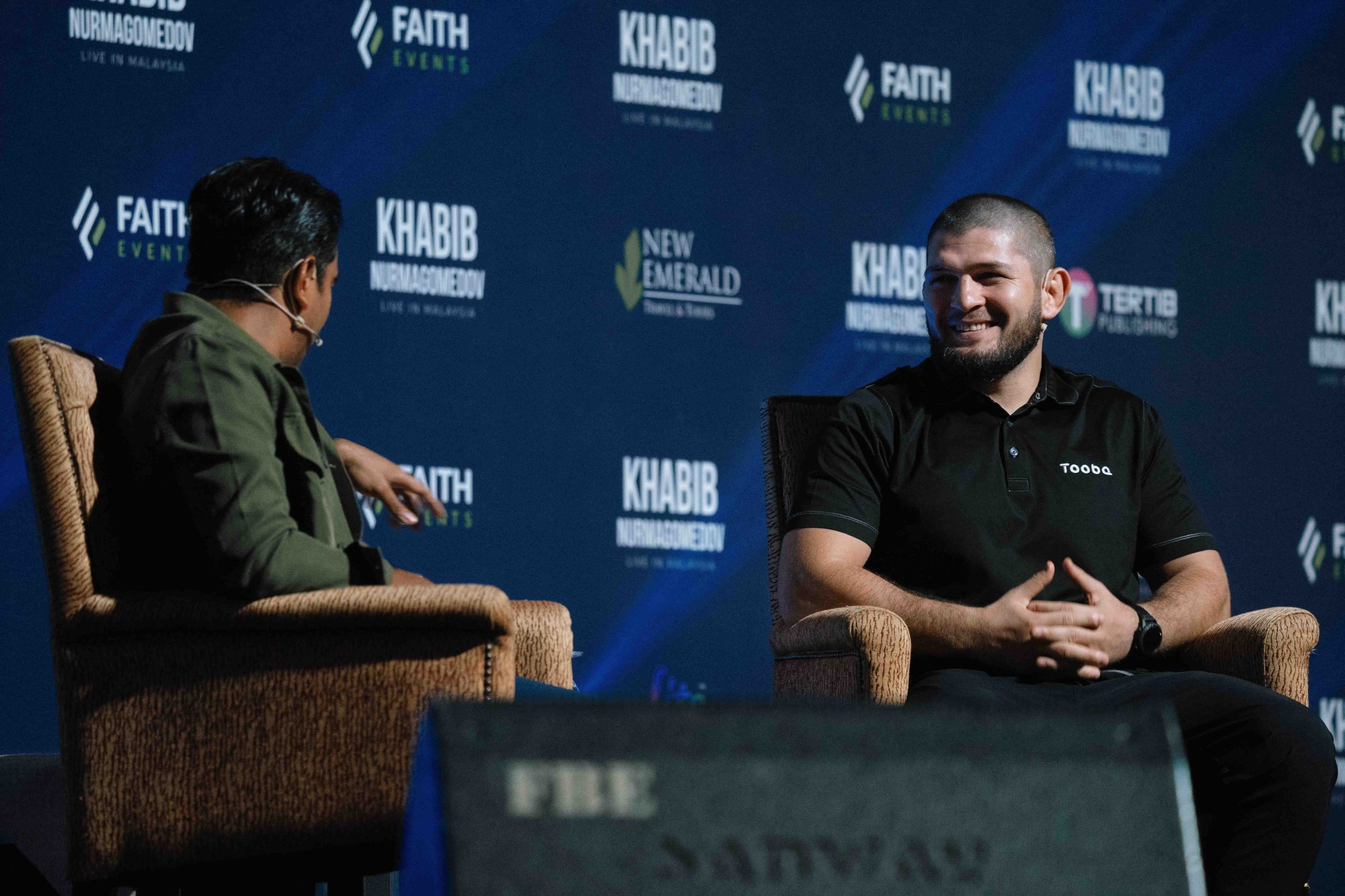 Khabib Nurmagomedov and Alif Satar on stage during Khabib's event