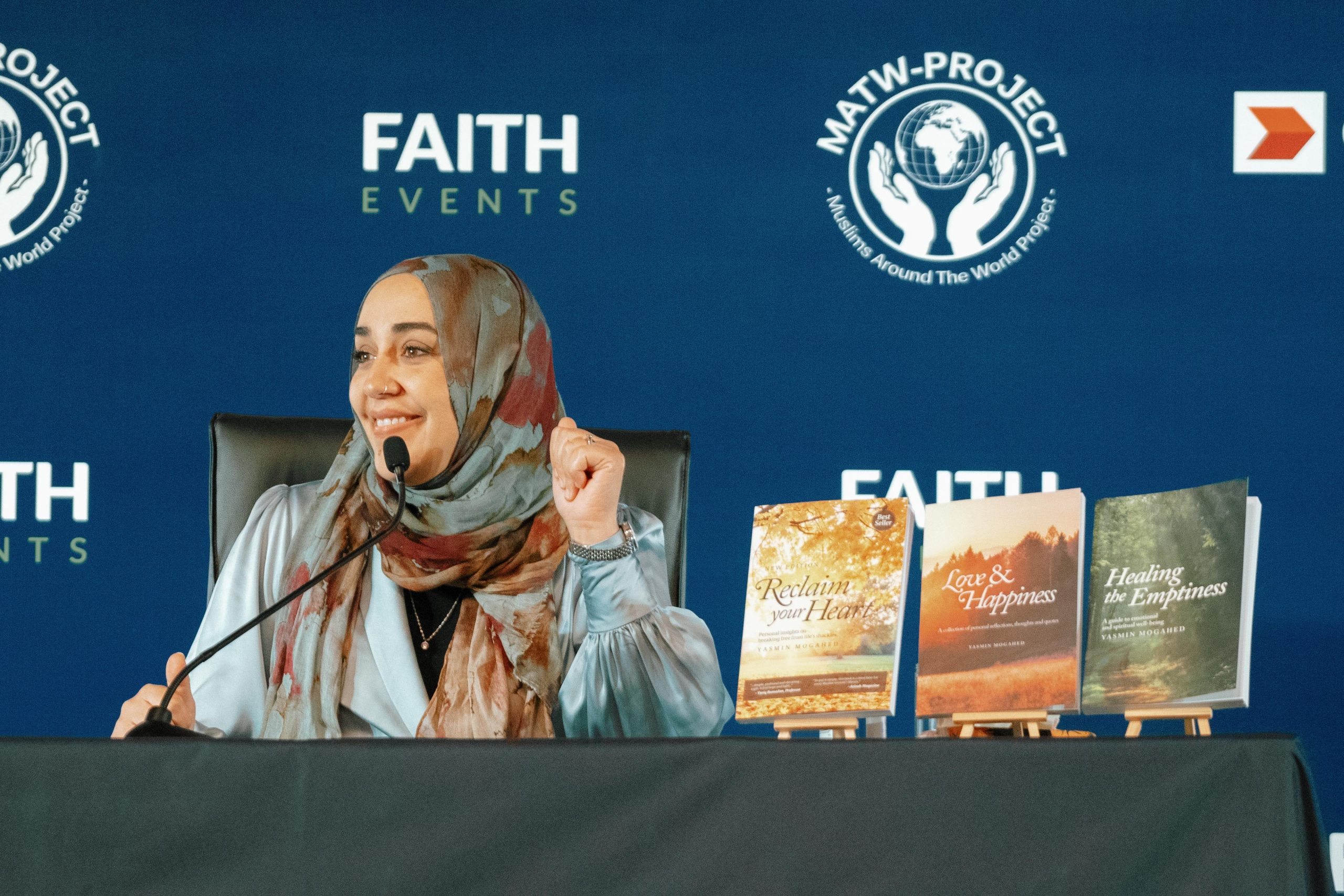 Yasmin Mogahed, sitting at the table during her talk. Her books are also displayed on the table